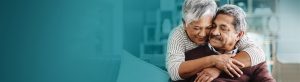 Older hispanic woman wrapping arms around older hispanic man