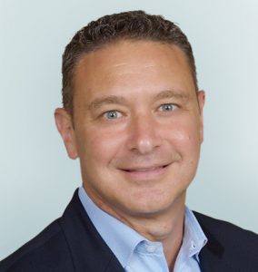 Headshot of Dominic Piscitelli Chief Financial Officer on light sage background
